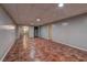 Finished basement area featuring neutral walls, tiled floor, and access to multiple rooms and closet at 5621 Wildwood Trl, Lithonia, GA 30038