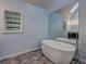 Modern bathroom featuring a stand-alone tub, a large mirror, and stylish tile floors at 5621 Wildwood Trl, Lithonia, GA 30038