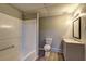 Bathroom featuring a shower-tub combo, neutral walls, and laminate flooring at 5621 Wildwood Trl, Lithonia, GA 30038