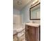 Bathroom featuring a toilet, vanity with a framed mirror above at 5621 Wildwood Trl, Lithonia, GA 30038