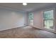 This bedroom has plush carpet and plenty of natural light at 5621 Wildwood Trl, Lithonia, GA 30038