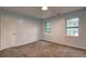 Bedroom featuring natural lighting, neutral paint colors, and plush carpeting at 5621 Wildwood Trl, Lithonia, GA 30038