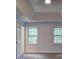 Bedroom features soft colors, tray ceilings, and natural light at 5621 Wildwood Trl, Lithonia, GA 30038