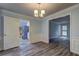 The dining room features wood-look floors and offers a view into the bright kitchen at 5621 Wildwood Trl, Lithonia, GA 30038