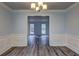 The dining room has classic molding and wood-look floors, with views to a bedroom at 5621 Wildwood Trl, Lithonia, GA 30038