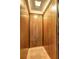 Interior of home elevator with rich wood panels, overhead lighting, and contrasting trim for a luxurious feel at 5621 Wildwood Trl, Lithonia, GA 30038