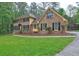 Beautiful home featuring a lush green lawn and a brick exterior with dark shutters at 5621 Wildwood Trl, Lithonia, GA 30038
