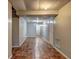 Basement hallway with neutral walls, recessed lights, and tile flooring leading to rooms and storage at 5621 Wildwood Trl, Lithonia, GA 30038