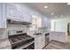 Kitchen featuring stainless steel appliances, white cabinets and stone countertops at 5621 Wildwood Trl, Lithonia, GA 30038