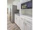 Modern kitchen displays white cabinets with granite countertop and stainless steel refrigerator at 5621 Wildwood Trl, Lithonia, GA 30038