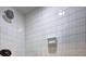 Bathroom showcasing white tiled shower and wall mounted shower head at 5621 Wildwood Trl, Lithonia, GA 30038