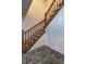 Staircase with wood railing and tile floor at 5621 Wildwood Trl, Lithonia, GA 30038
