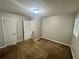 Standard bedroom with neutral walls and brown carpet, features a closet door at 1263 Shoreham Dr, Atlanta, GA 30349