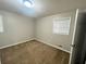 Cozy bedroom with carpeted floors, a window, and neutral walls at 1263 Shoreham Dr, Atlanta, GA 30349