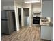 Galley kitchen featuring stainless steel appliances, and gray and white cabinets at 1263 Shoreham Dr, Atlanta, GA 30349