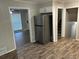 Kitchen featuring stainless steel refrigerator and views of stairs and living area at 1263 Shoreham Dr, Atlanta, GA 30349
