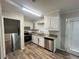 Kitchen featuring stainless steel appliances, white cabinets, and granite countertops at 1263 Shoreham Dr, Atlanta, GA 30349