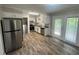 Kitchen featuring stainless steel appliances, white cabinets, and wood flooring at 1263 Shoreham Dr, Atlanta, GA 30349