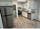 Well-lit kitchen with stainless steel appliances, gray cabinets and modern countertops at 1263 Shoreham Dr, Atlanta, GA 30349