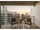 Relaxing balcony area showcasing two chairs with city views during a beautiful sunset at 20 10Th Nw St # 2003, Atlanta, GA 30309