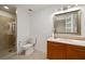 Modern bathroom featuring a glass-enclosed shower and vanity with a stylish mirror at 20 10Th Nw St # 2003, Atlanta, GA 30309
