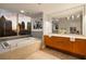 Luxurious bathroom featuring a soaking tub with skyline views during sunset at 20 10Th Nw St # 2003, Atlanta, GA 30309