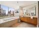 Luxurious bathroom featuring a soaking tub with skyline views at 20 10Th Nw St # 2003, Atlanta, GA 30309