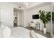 Bright bedroom featuring modern gray tile floors, a work space, and a large leafy plant at 20 10Th Nw St # 2003, Atlanta, GA 30309
