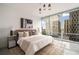 Bright bedroom with a large window offering impressive city views and a modern aesthetic at 20 10Th Nw St # 2003, Atlanta, GA 30309