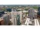 An expansive city view with various modern buildings, high-rises, and lush trees in the background at 20 10Th Nw St # 2003, Atlanta, GA 30309