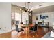 Modern dining room featuring a round wooden table, stylish chairs, and a unique light fixture at 20 10Th Nw St # 2003, Atlanta, GA 30309