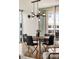 Contemporary dining room with a round table, sleek black chairs, and modern lighting at 20 10Th Nw St # 2003, Atlanta, GA 30309
