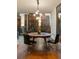This dining area showcases dark wood floors with a round table, black chairs, and city views at 20 10Th Nw St # 2003, Atlanta, GA 30309