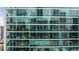 Exterior shot of building with a wall of windows showing multiple apartments inside at 20 10Th Nw St # 2003, Atlanta, GA 30309