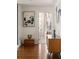 Hallway showcases wood floors leading to a bedroom with artwork and modern decor at 20 10Th Nw St # 2003, Atlanta, GA 30309