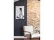 Cozy sitting area with a stone wall, modern chair, and painting at 20 10Th Nw St # 2003, Atlanta, GA 30309