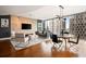 Elegant living room with a stone accent wall, hardwood floors, and a stunning city view through expansive windows at 20 10Th Nw St # 2003, Atlanta, GA 30309