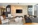 Inviting open-concept living room with modern furniture, a stone accent wall, and a flat-screen TV at 20 10Th Nw St # 2003, Atlanta, GA 30309