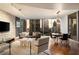 Warm living room featuring hardwood floors, modern furniture, and a beautiful city view through expansive windows at 20 10Th Nw St # 2003, Atlanta, GA 30309