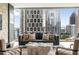 Bright living room showcasing floor-to-ceiling windows with panoramic city views and modern decor at 20 10Th Nw St # 2003, Atlanta, GA 30309