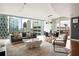 Bright living room featuring hardwood floors, modern lighting, and a breathtaking city view through large windows at 20 10Th Nw St # 2003, Atlanta, GA 30309