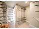 Modern walk-in closet with metal shelving and a frosted glass door for storage at 20 10Th Nw St # 2003, Atlanta, GA 30309