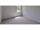 Cozy bedroom featuring neutral carpet and a sunlit window at 210 Park Place Trl, Social Circle, GA 30025