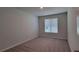 Carpeted bedroom with a window and ample natural light at 210 Park Place Trl, Social Circle, GA 30025