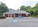 Community clubhouse with a brick exterior and ample parking at 210 Park Place Trl, Social Circle, GA 30025