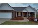 Charming brick home with a well-manicured lawn and an attached garage at 210 Park Place Trl, Social Circle, GA 30025