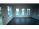 Bright living room with dark floors and multiple large windows at 210 Park Place Trl, Social Circle, GA 30025