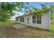 Backyard with a stone patio, lush trees and grass and a white vinyl siding home at 5478 Somer Mill Rd, Douglasville, GA 30134