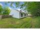 Backyard with green grass, a stone patio and white siding with dark trim at 5478 Somer Mill Rd, Douglasville, GA 30134