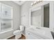 Bathroom with a white vanity, large mirror, wood-look flooring, and natural light from the window at 5478 Somer Mill Rd, Douglasville, GA 30134